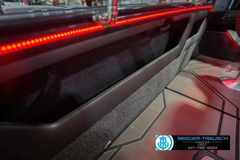 Slide: The Image of 2026 Lund 1875 Crossover XS with Mercury outboard motor in showroom setting. - 45