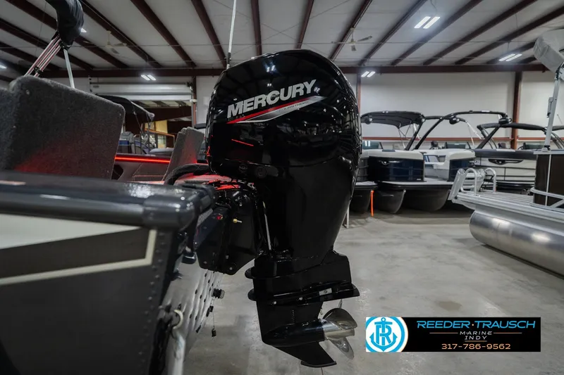 Slide: The Image of 2026 Lund 1875 Crossover XS boat engine with 150 horsepower, displayed indoors. - 47