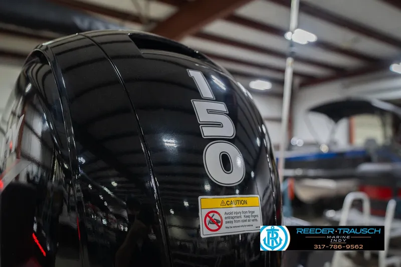 Slide: The Image of 2026 Lund 1875 Crossover XS boat propeller in a showroom setting. - 49