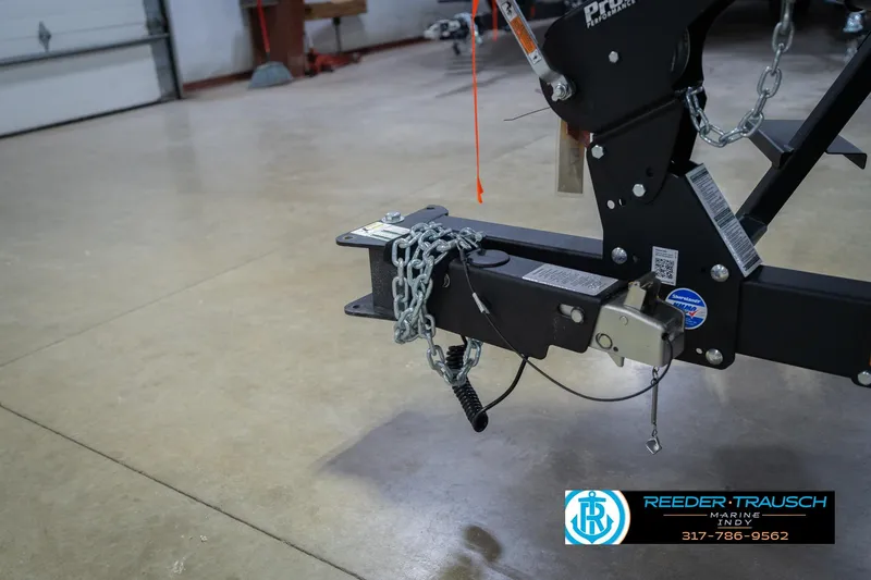 Slide: The Image of 2026 Lund 1875 Crossover XS boat logo on black surface. - 55