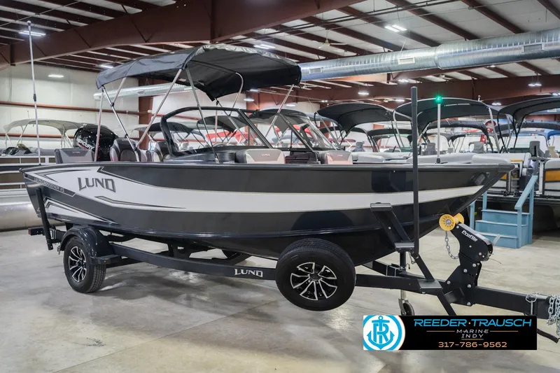 Slide: The Image of 2026 Lund 1875 Crossover XS boat with Mercury engine in showroom, Reeder-Trausch Marine. - 6