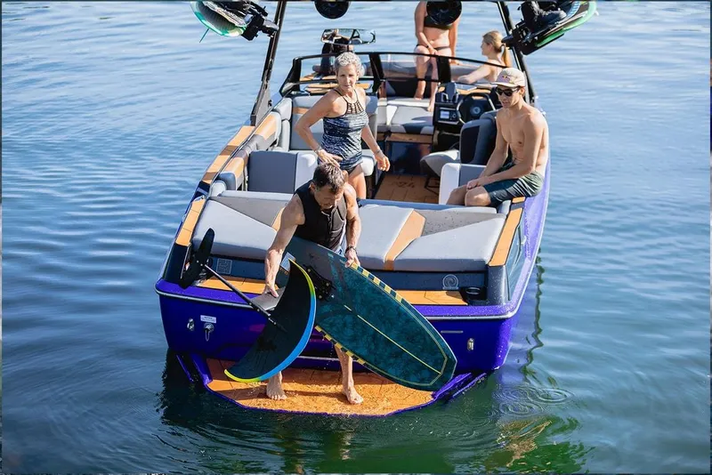 Slide: The Image of 2023 Axis A24 boat on trailer outside dealership, featuring sleek design and modern features. - 2