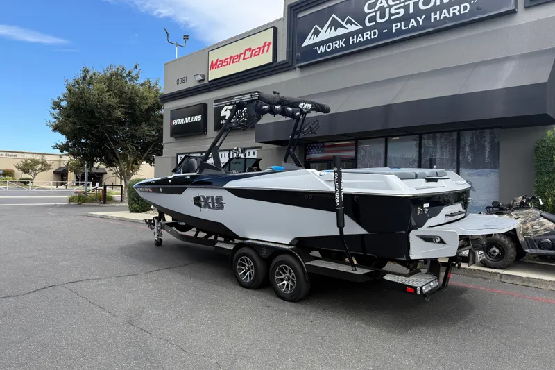 Slide: The Image of 2023 Axis A24 boat on trailer outside dealership, showcasing sleek design. - 4