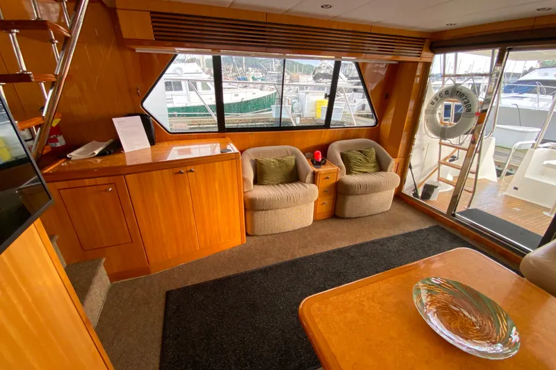 Slide: The Image of Luxurious 2001 Compass 57 yacht interior with plush seating and elegant wood finishes. - 10