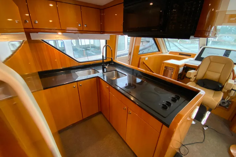 Slide: The Image of Luxurious kitchen interior of 2001 Compass 57 yacht with modern appliances and sleek design. - 12
