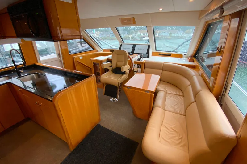 Slide: The Image of Luxurious interior of 2001 Compass 57 yacht with leather seating and modern navigation equipment. - 14