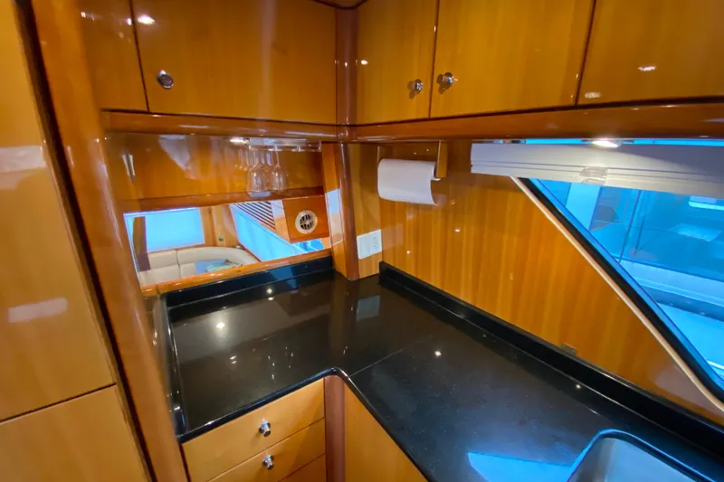 Slide: The Image of Luxurious wooden interior of 2001 Compass 57 yacht with sleek black countertop. - 16