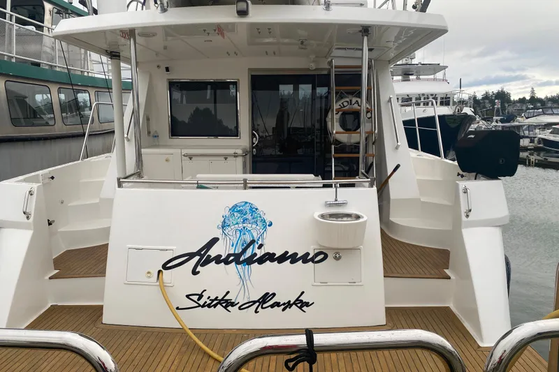 Slide: The Image of Rear view of 2001 Compass 57 yacht named "Andiamo" docked in Sitka, Alaska. - 2