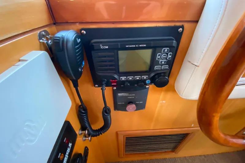 Slide: The Image of VHF marine radio setup on Compass 57, 2001 model, with microphone and control panel. - 23