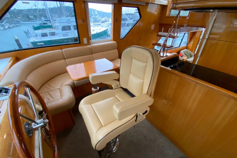 Slide: The Image of Luxurious interior of 2001 Compass 57 yacht with leather seating and wooden accents. - 27
