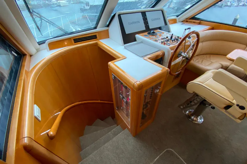 Slide: The Image of Luxurious 2001 Compass 57 yacht helm with leather seating and advanced navigation systems. - 30