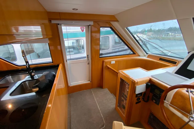 Slide: The Image of Interior of 2001 Compass 57 yacht with sleek wood finish and modern helm. - 31