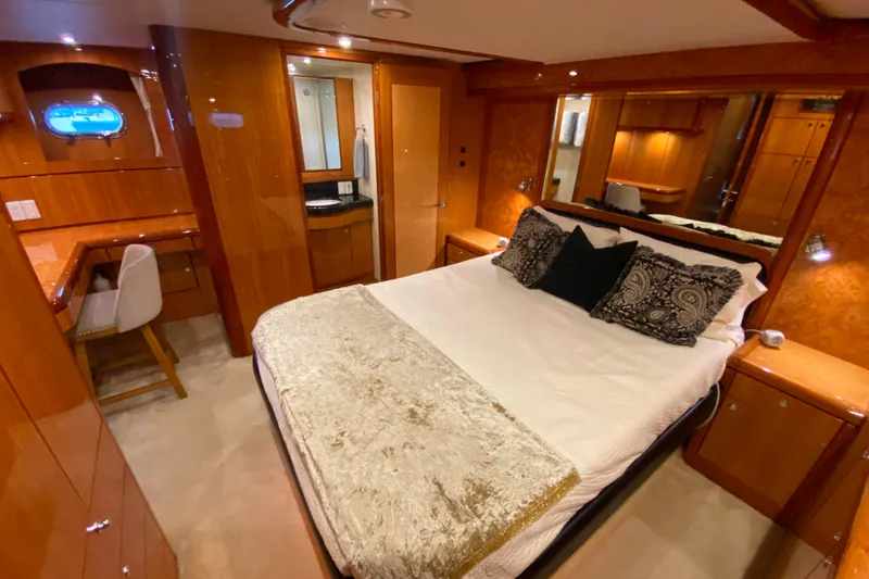 Slide: The Image of Luxurious bedroom in 2001 Compass 57 yacht with elegant wood finishes and plush bedding. - 33