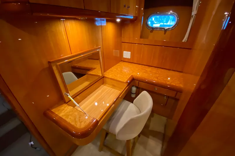 Slide: The Image of Luxurious wooden vanity area with mirror and chair in 2001 Compass 57 yacht. - 35