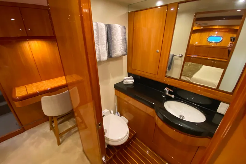 Slide: The Image of Luxurious yacht bathroom with wooden cabinetry, black countertop, and modern fixtures, Compass 57, 2001 model. - 38