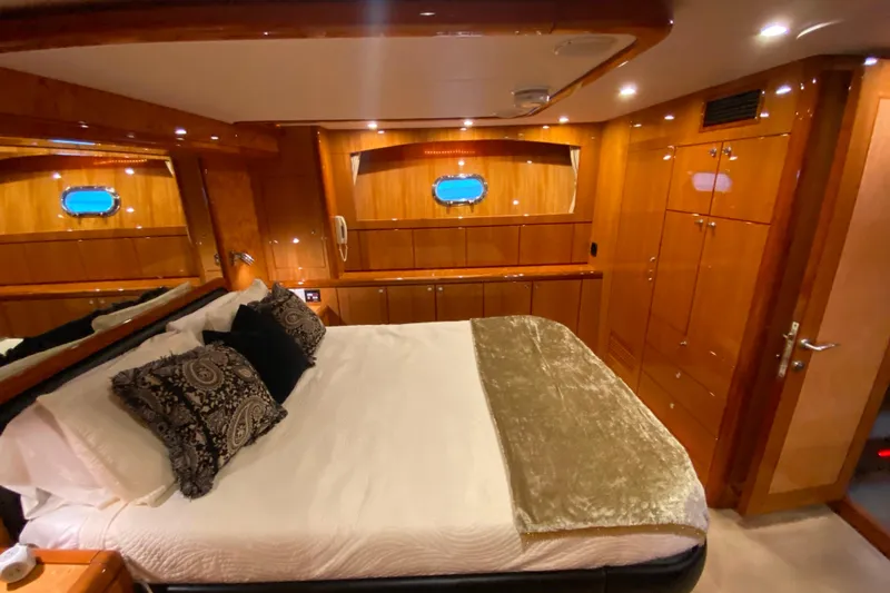 Slide: The Image of Luxurious cabin interior of 2001 Compass 57 yacht with elegant wood finish and cozy bedding. - 39