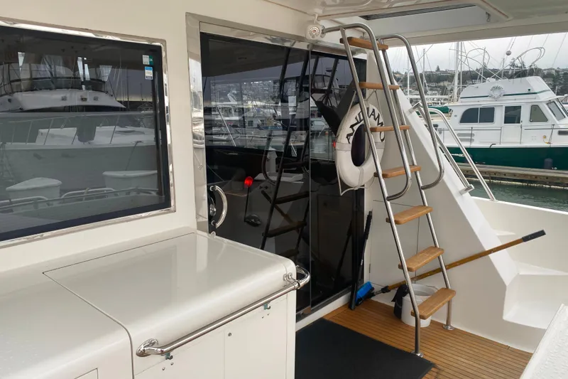 Slide: The Image of 2001 Compass 57 yacht deck with ladder and marina view. - 4