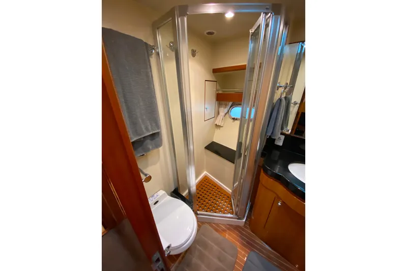 Slide: The Image of Compact bathroom in 2001 Compass 57 yacht with shower, toilet, and sink. - 40