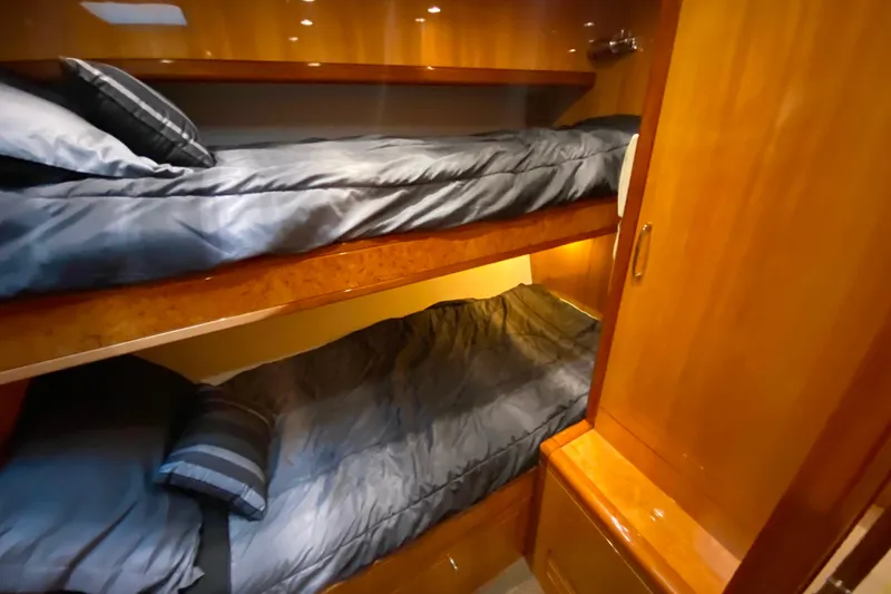 Slide: The Image of Bunk beds in a 2001 Compass 57 yacht cabin with wooden interior. - 48