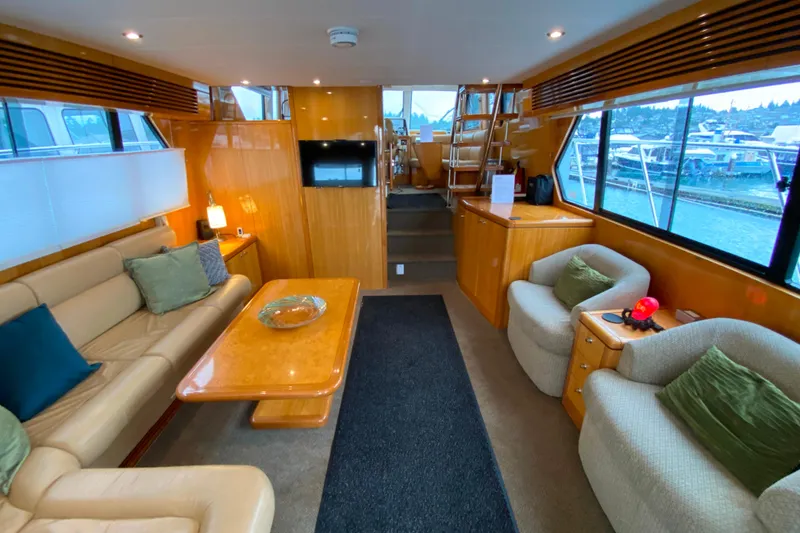 Slide: The Image of Luxurious interior of 2001 Compass 57 yacht with plush seating and elegant wood finishes. - 5