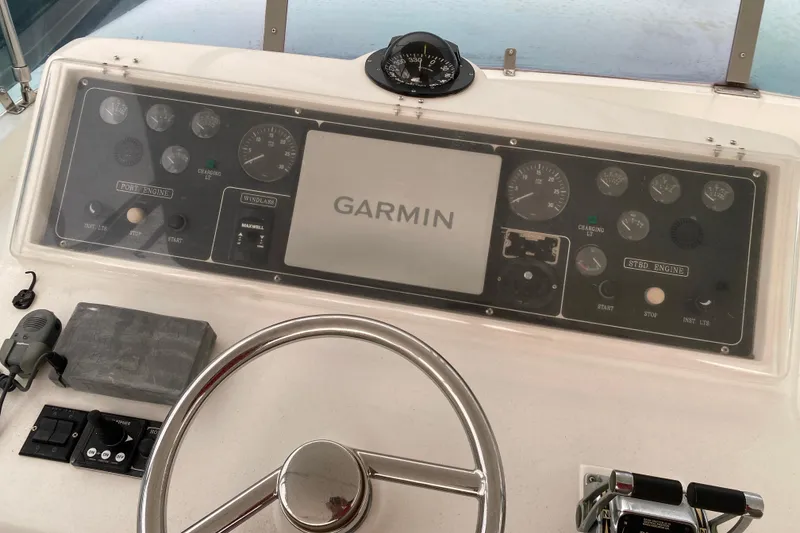 Slide: The Image of Boat dashboard with Garmin display, compass, and controls, Compass 57 model, 2001. - 51