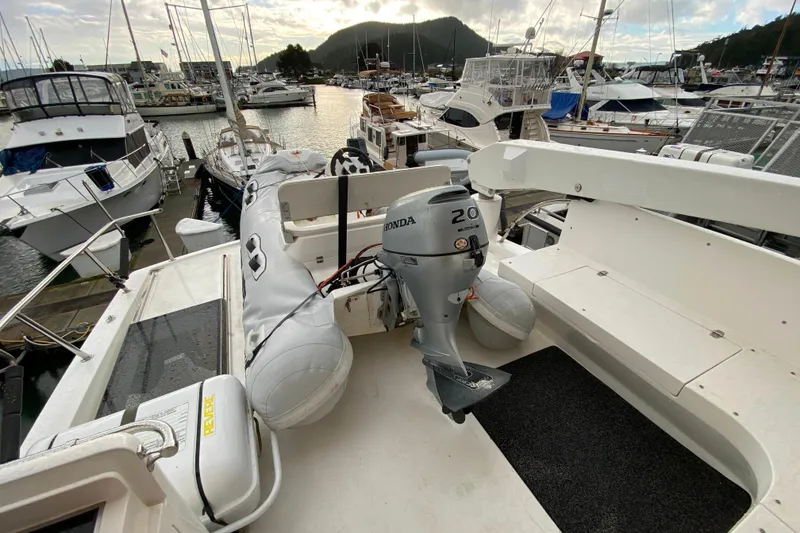 Slide: The Image of Compass 57 boat, 2001 model, with Honda outboard motor, docked at marina. - 55