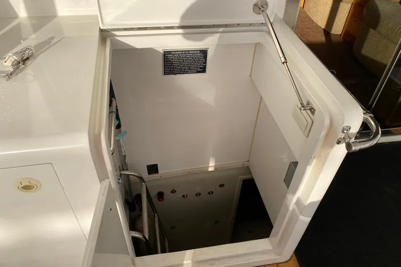 Slide: The Image of Engine room access hatch on a 2001 Compass 57 yacht, showing interior details. - 58