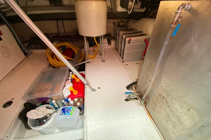 Slide: The Image of Engine room of 2001 Compass 57 yacht with storage and equipment. - 60