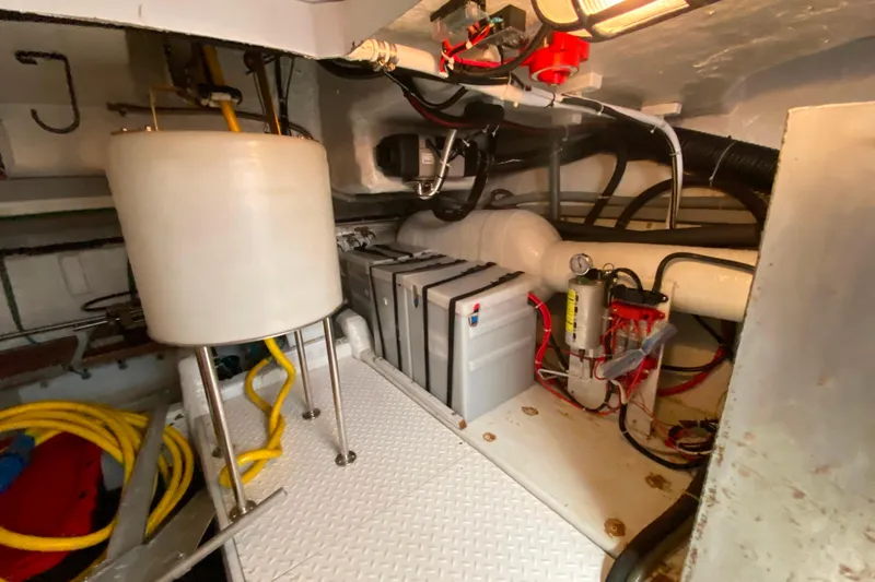 Slide: The Image of Engine room of a 2001 Compass 57 yacht, featuring equipment and wiring. - 61