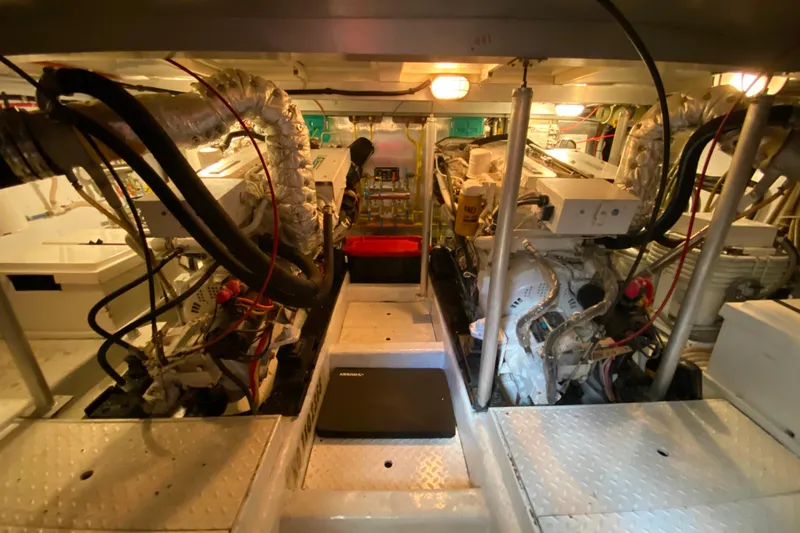 Slide: The Image of Engine room of a 2001 Compass 57 yacht, showcasing dual engines and mechanical components. - 63