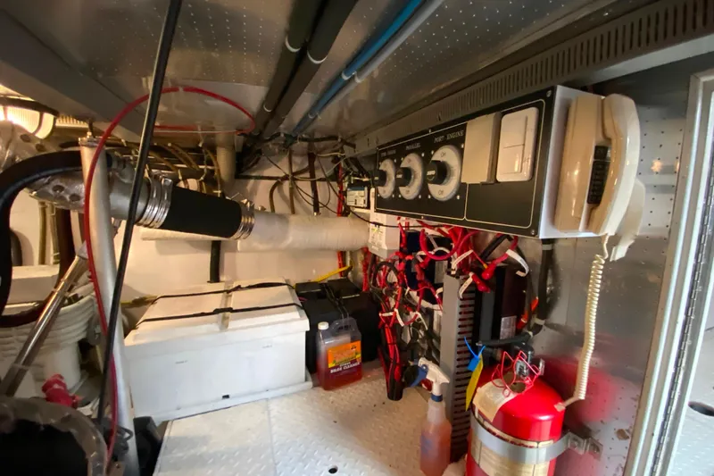 Slide: The Image of Engine room of 2001 Compass 57 with control panel, wiring, and safety equipment. - 65