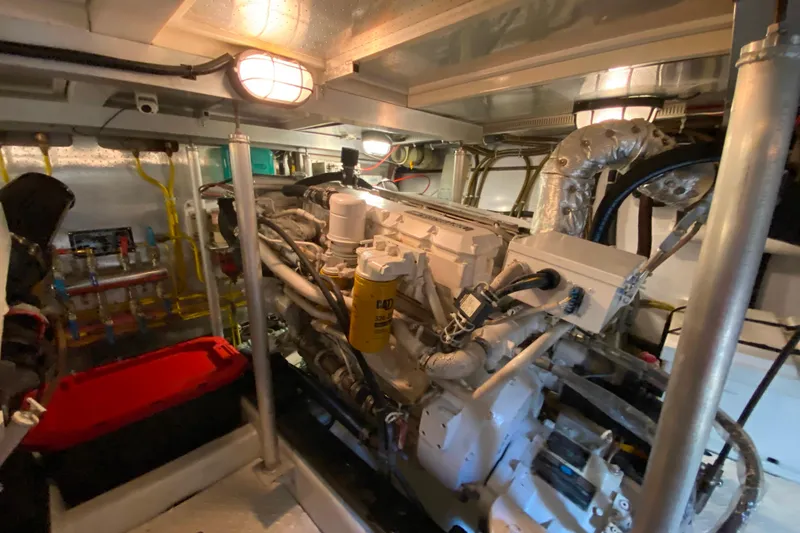 Slide: The Image of Engine room of a 2001 Compass 57 yacht, featuring complex machinery and piping. - 66
