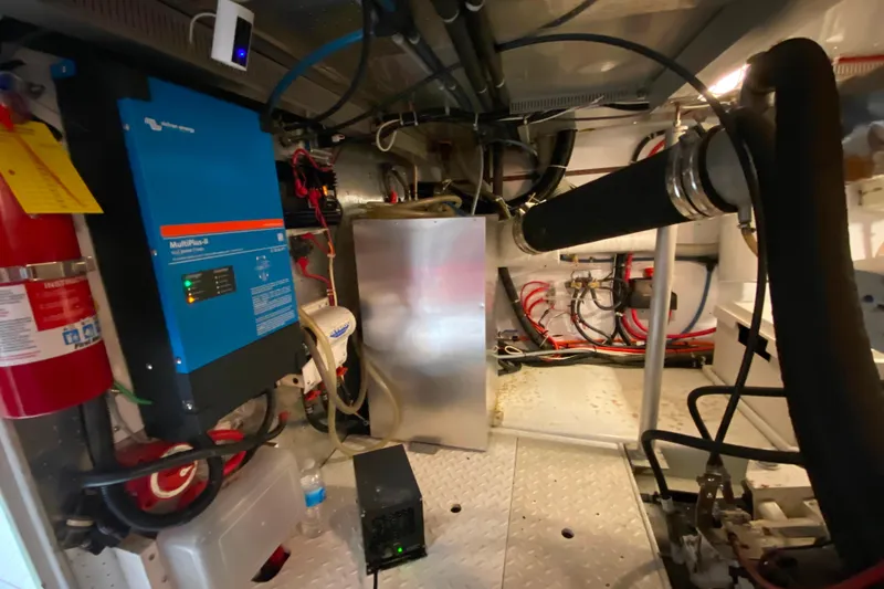 Slide: The Image of Engine room of a 2001 Compass 57 yacht with electrical equipment and fire extinguisher. - 67