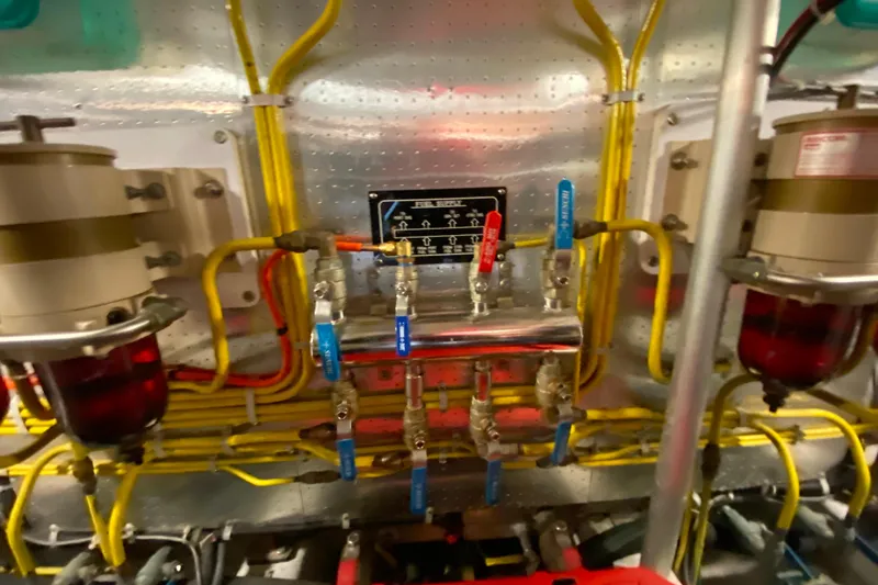 Slide: The Image of Engine room of 2001 Compass 57 yacht with complex piping and valves. - 68