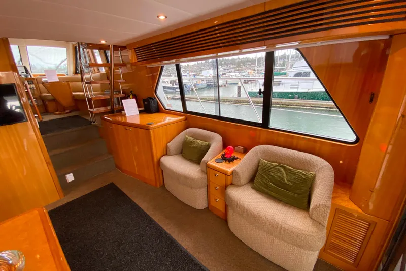 Slide: The Image of Luxurious interior of 2001 Compass 57 yacht with cozy seating and marina view. - 7