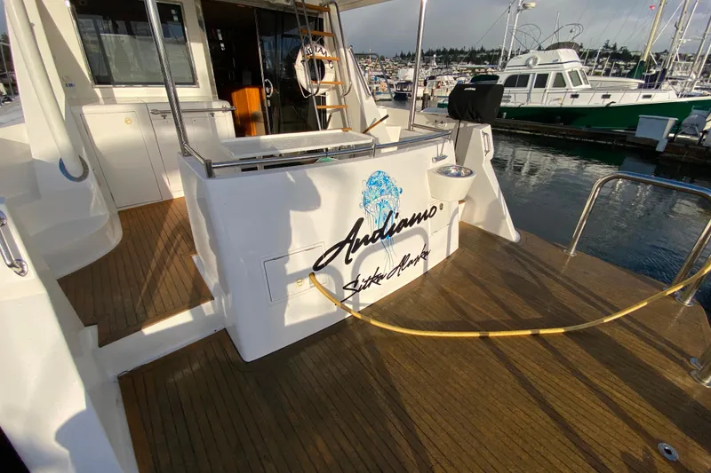 Slide: The Image of Compass 57 yacht, 2001 model, docked with wooden deck and marina view. - 72