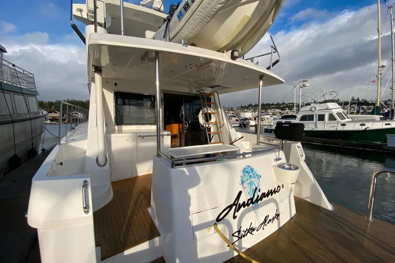 Slide: The Image of Luxury yacht Compass 57, 2001 model, docked at marina with clear skies. - 73
