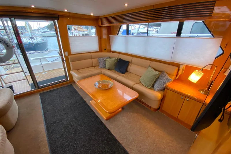 Slide: The Image of Luxurious interior of 2001 Compass 57 yacht with cozy seating and elegant decor. - 8