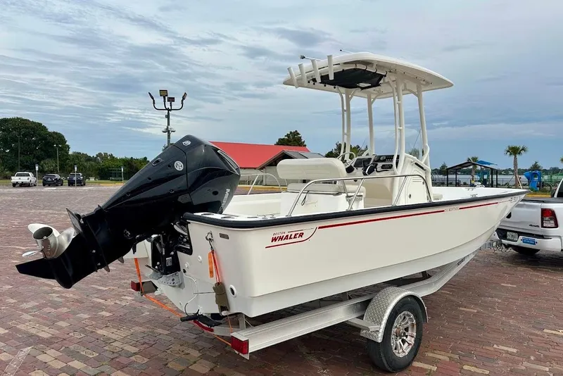 Slide: The Image of 2023 Boston Whaler 210 Montauk boat on trailer, parked outdoors. - 10