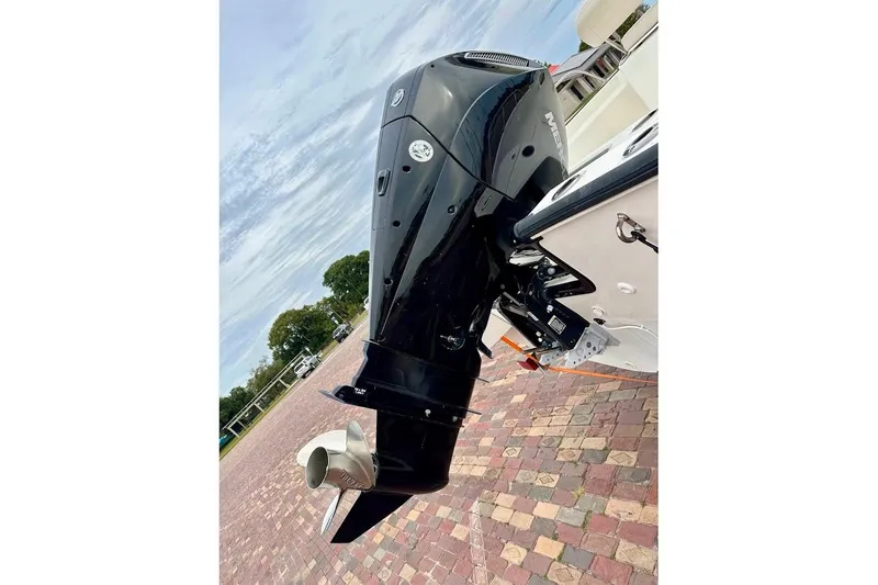 Slide: The Image of 2023 Boston Whaler 210 Montauk with Mercury outboard engine on a brick driveway. - 13