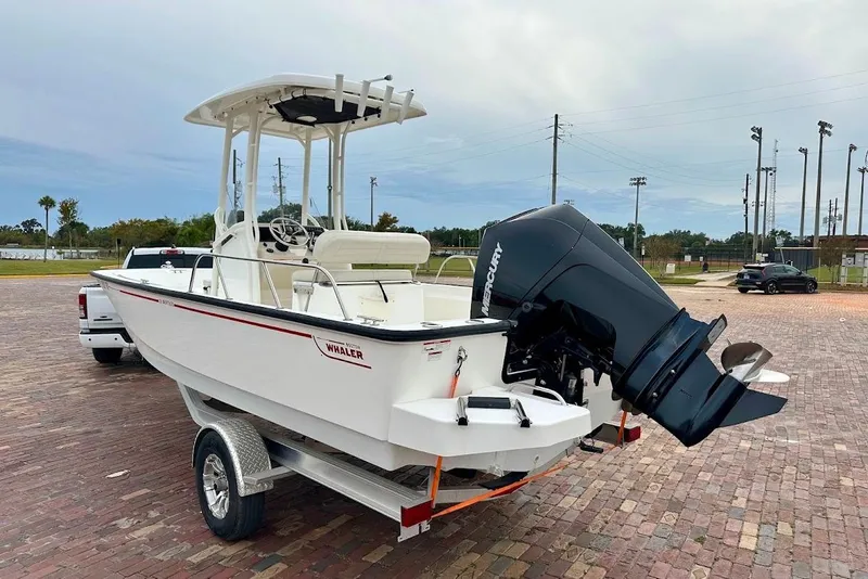 Slide: The Image of 2023 Boston Whaler 210 Montauk boat on trailer, featuring Mercury outboard motor. - 3