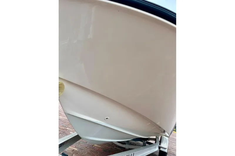 Slide: The Image of 2023 Boston Whaler 210 Montauk boat hull on trailer, close-up view. - 5