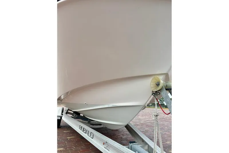 Slide: The Image of 2023 Boston Whaler 210 Montauk boat on a Robalo trailer, close-up view. - 6