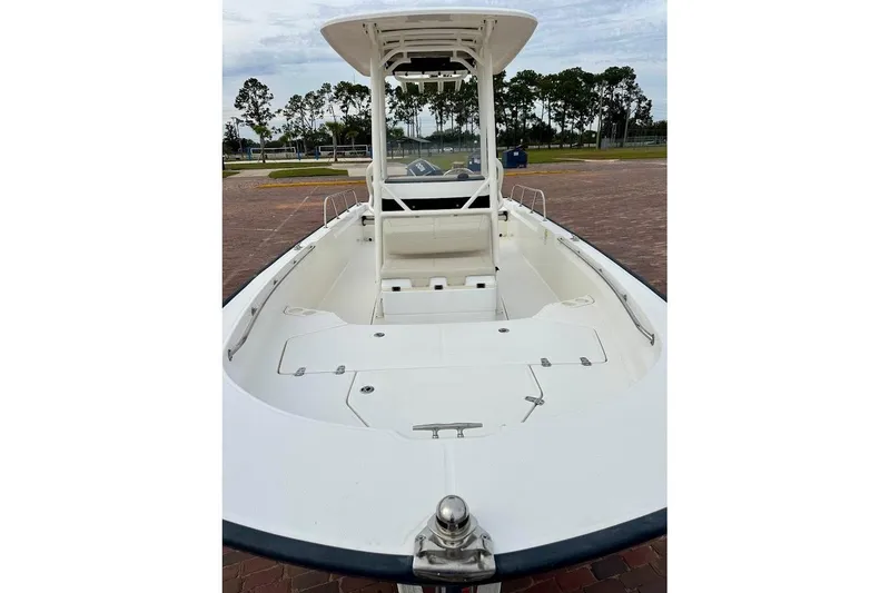 Slide: The Image of 2023 Boston Whaler 210 Montauk boat, spacious deck, sleek design, parked outdoors. - 7