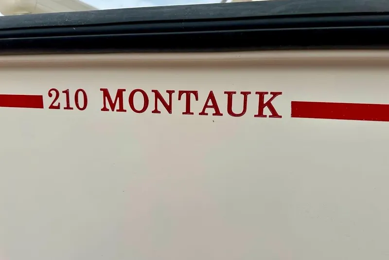 Slide: The Image of 2023 Boston Whaler 210 Montauk boat nameplate in red lettering. - 8