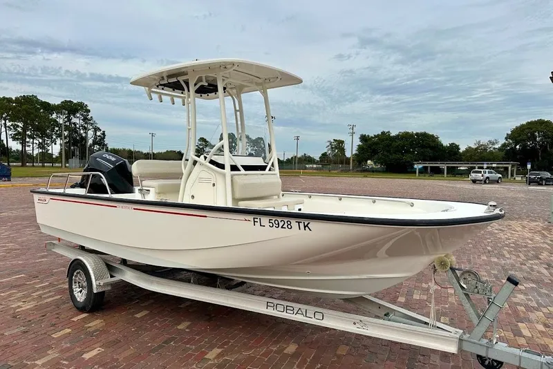 Slide: The Image of 2023 Boston Whaler 210 Montauk boat on trailer, parked on brick pavement. - 9