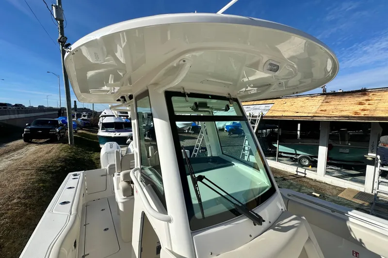 Slide: The Image of Boston Whaler 280 Outrage 2026 at a boatyard. - 13