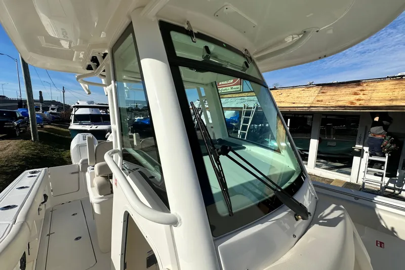 Slide: The Image of 2026 Boston Whaler 280 Outrage, modern boat roof and cockpit. - 18