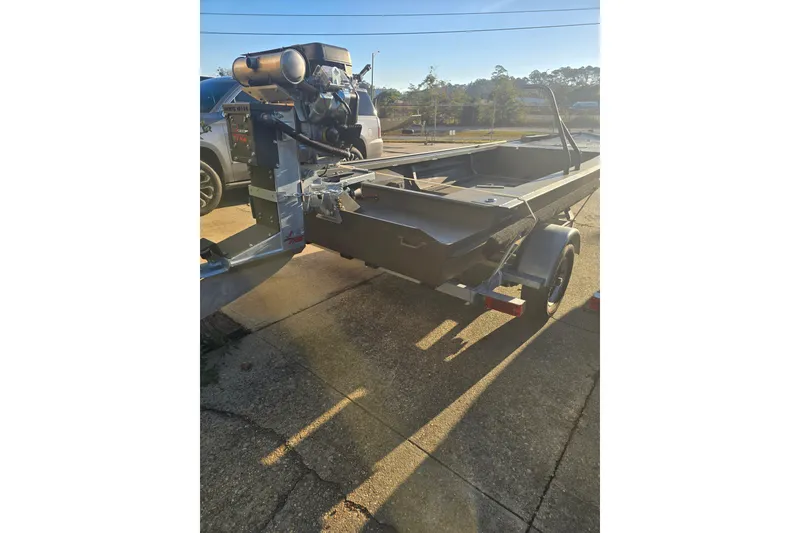 The Image of 2026 Go-Devil 18x60 Surface Drive Boat on trailer, parked outdoors. - 1