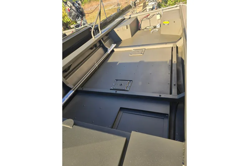 Slide: The Image of 2026 Go-Devil 18x60 Surface Drive Boat interior with storage compartments and metal framework. - 4